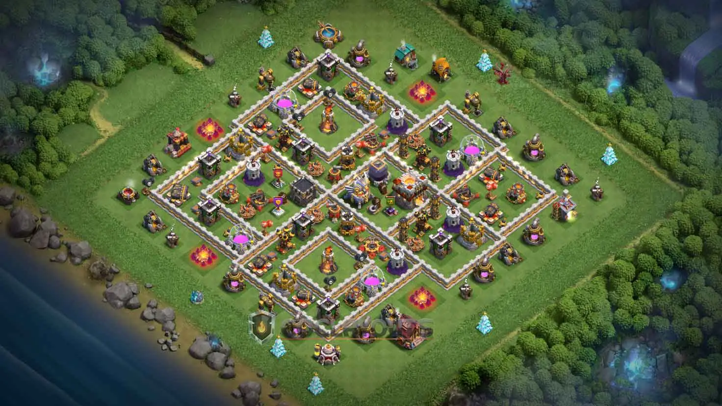 A clash of clans th11 base with resource bins placed in separate compartments along the outer defensive ring.