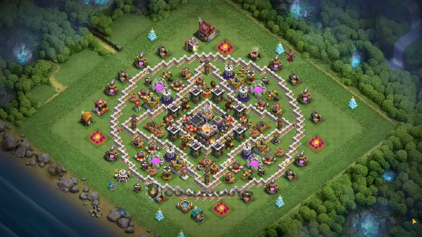 A clash of clans th11 base featuring a beautiful symmetrical layout with decentralized resource storages for farming.