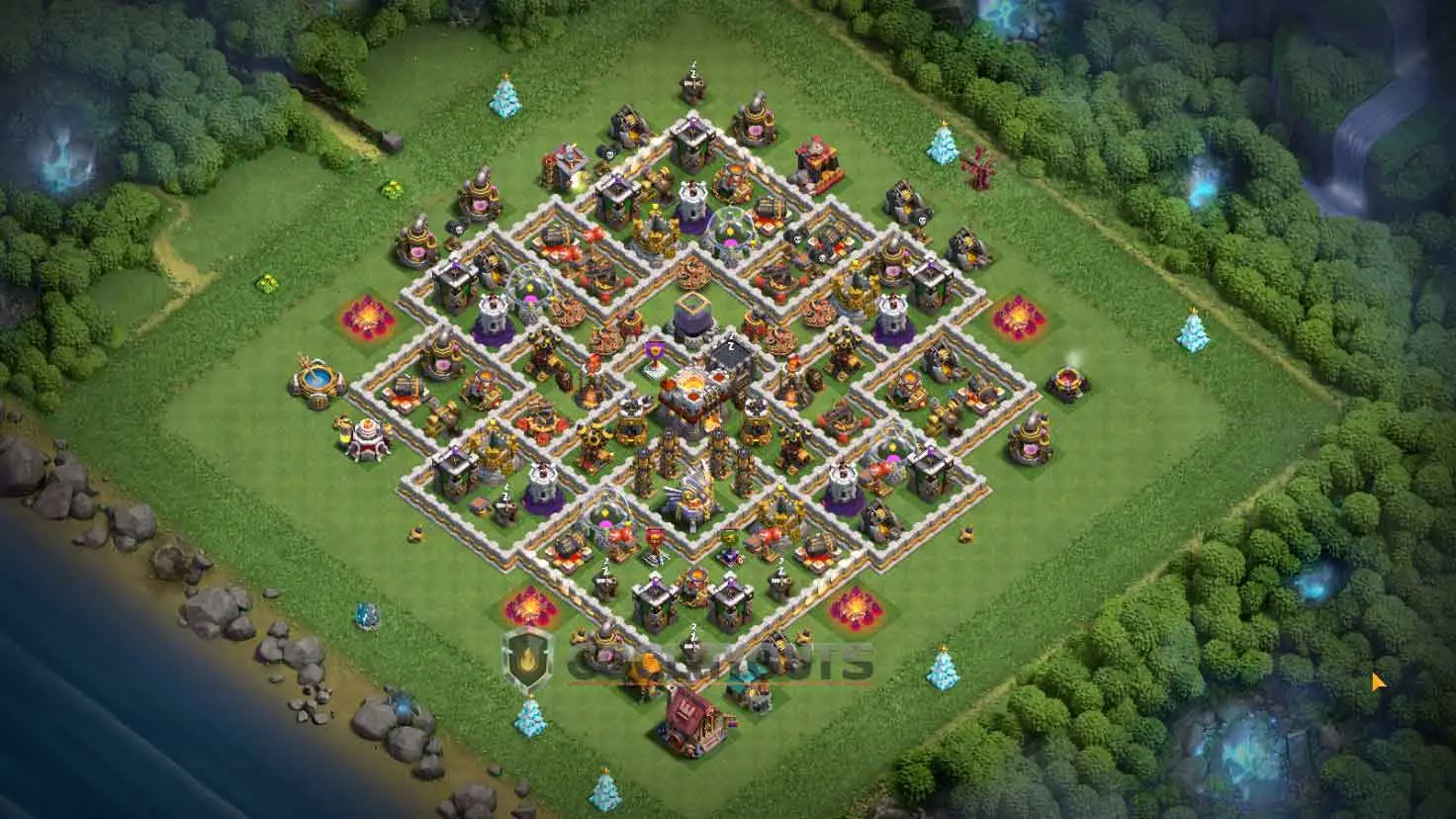 A clash of clans th11 hybrid base featuring multiple small wall compartments to stall enemy troops and control pathing.